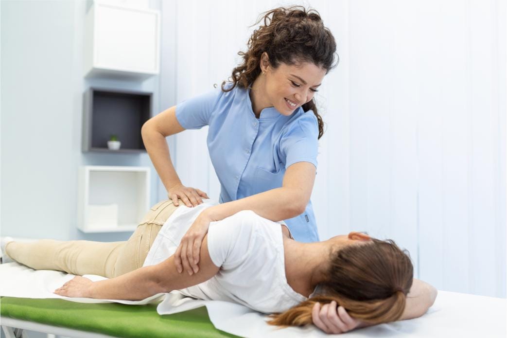 Physiotherapist assisting a patient with a home physiotherapy session